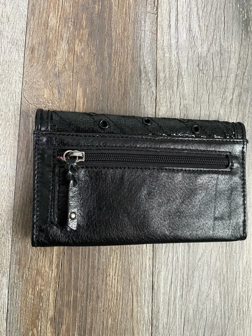 The Sak Black Quilted Eyelet Trifold Leather Wallet with Logo Plaque